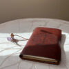 Oxblood Chakra Body Crystal Journal featuring embossed design and lined pages"