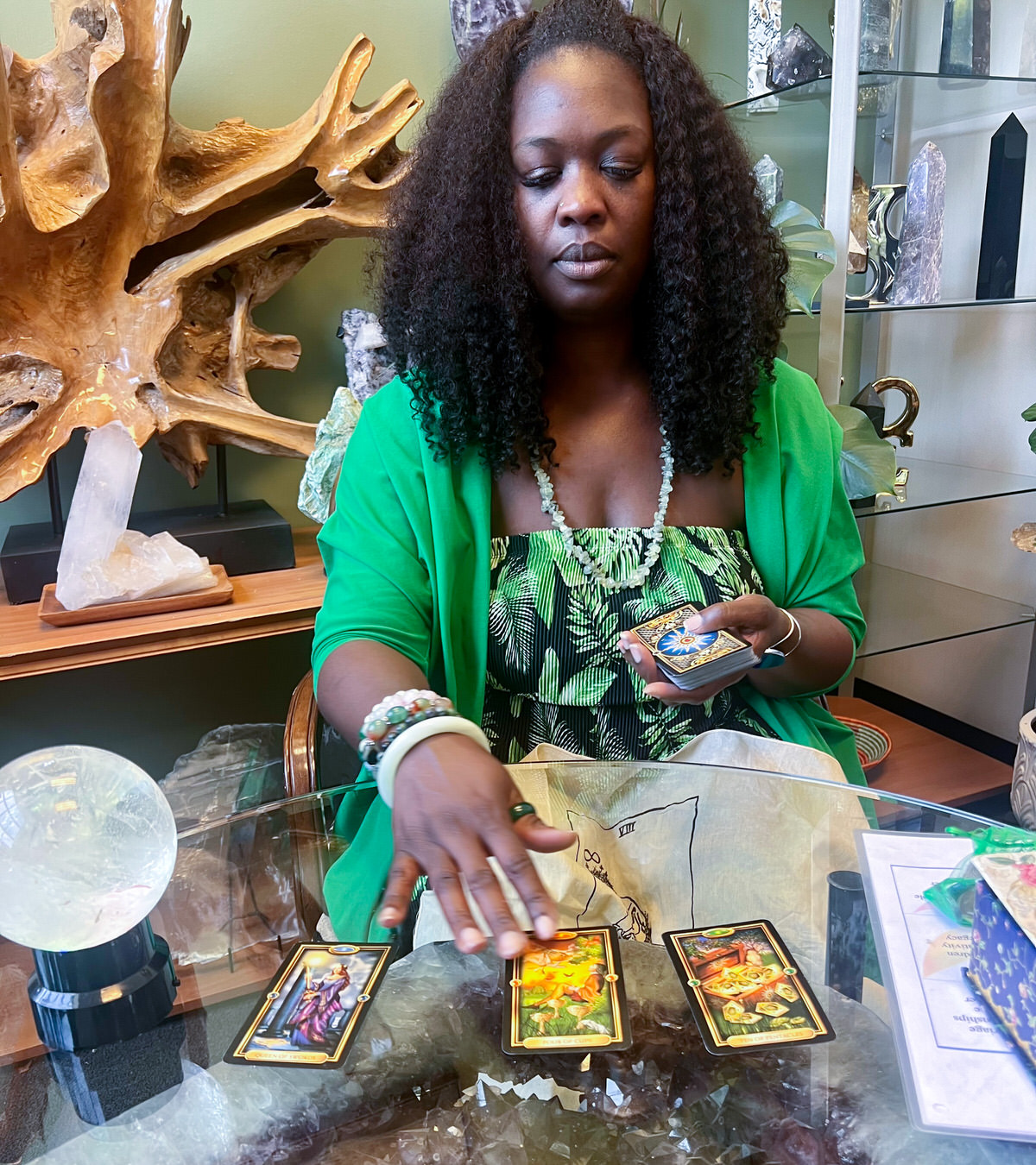 Close-up of a hand drawing a Tarot card from a deck, with mystical symbols in the background, representing the act of seeking answers and uncovering hidden truths through divination