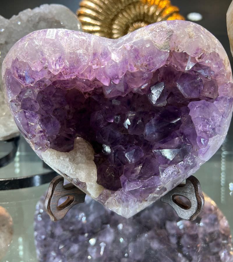 Amethyst heart crystal radiating calming energy, promoting peace, spiritual growth, and emotional healing with its soothing purple hues.