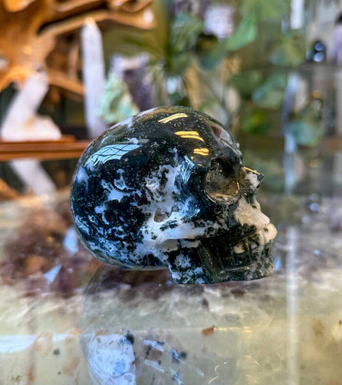 Promote growth, abundance, and emotional balance with the Moss Agate Skull