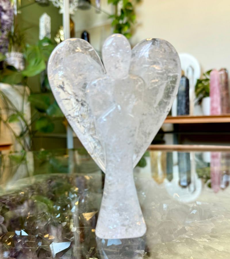 Clear quartz crystal angel figurine, intricately carved with transparent, details, symbolizing clarity and spiritual healing