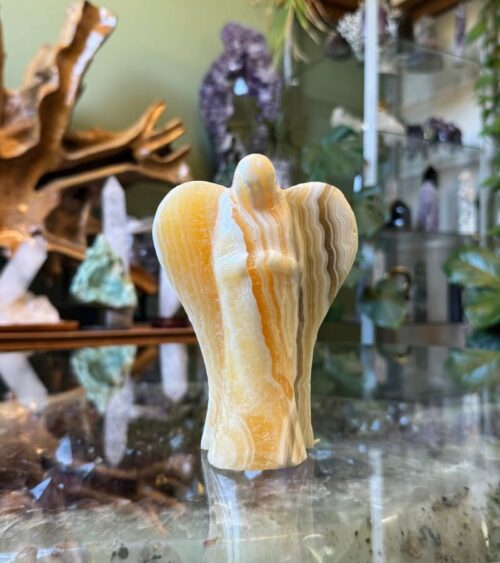 Known as a stone of motivation, our Banded Orange Calcite Crystal Angel encourages you to embrace your passions and cultivate a joyful mindset.