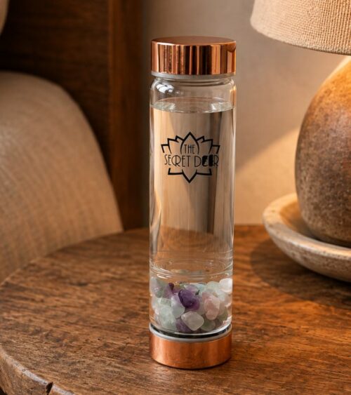 Flourite Crystal Water Bottle - Rose Gold on Bed Side Table